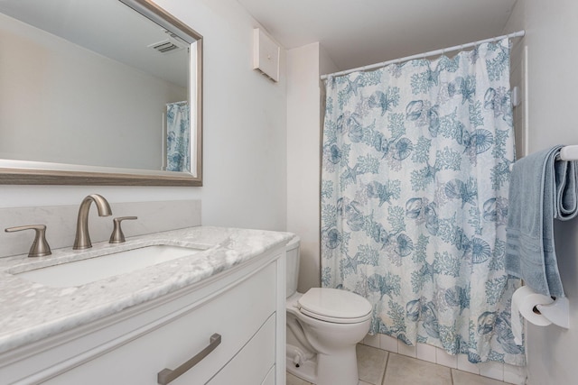 bathroom with vanity, toilet, and tile patterned flooring