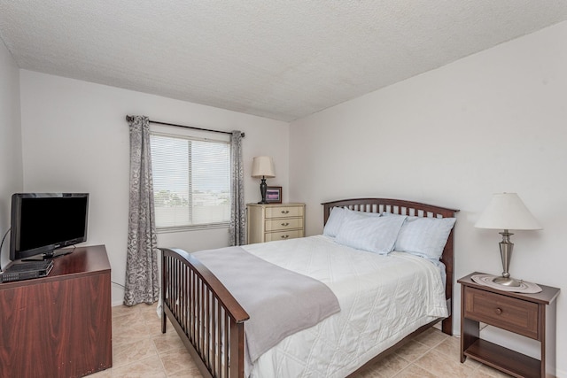 tiled bedroom featuring a textured ceiling