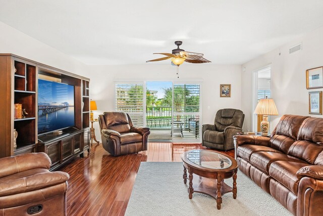 living room with ceiling fan and hardwood / wood-style floors