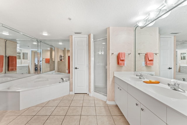 bathroom featuring independent shower and bath, vanity, tile patterned flooring, and a textured ceiling