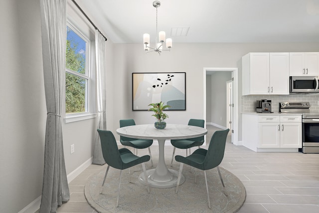 tiled dining room featuring a notable chandelier