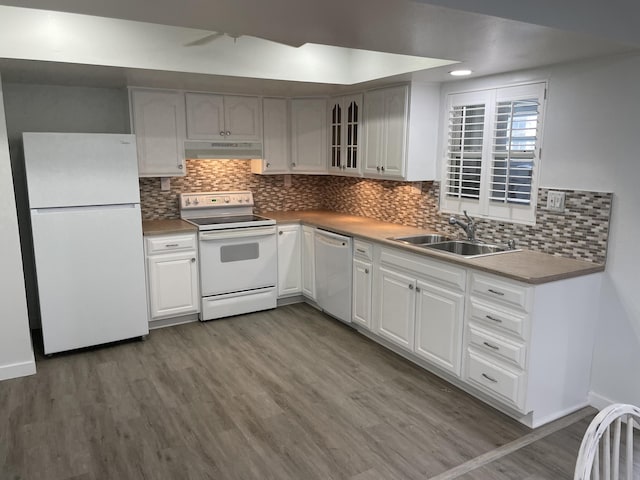 kitchen featuring white appliances, sink, light hardwood / wood-style flooring, and white cabinets