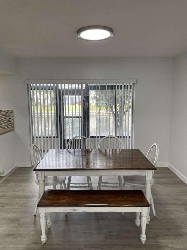 dining space with wood-type flooring