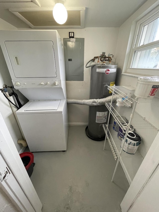 washroom featuring electric water heater, stacked washer / drying machine, and electric panel