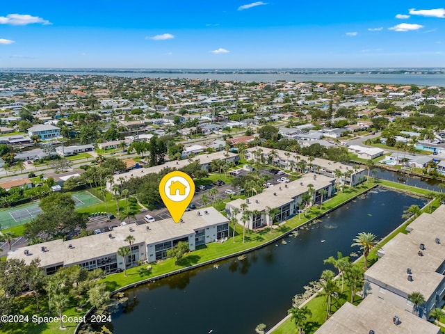 drone / aerial view with a water view and a residential view