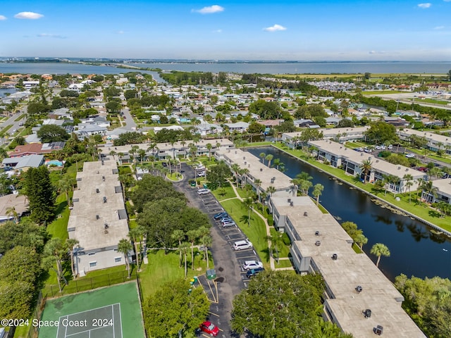 birds eye view of property with a water view and a residential view