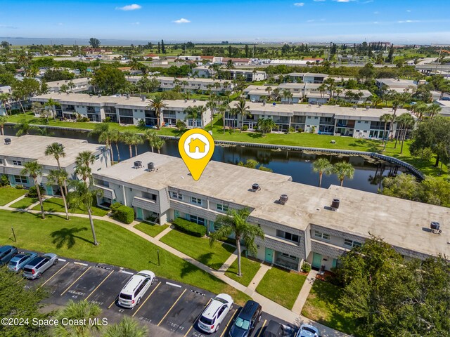 drone / aerial view with a water view and a residential view