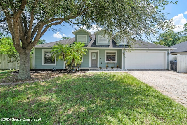 view of front of house featuring a garage and a front lawn