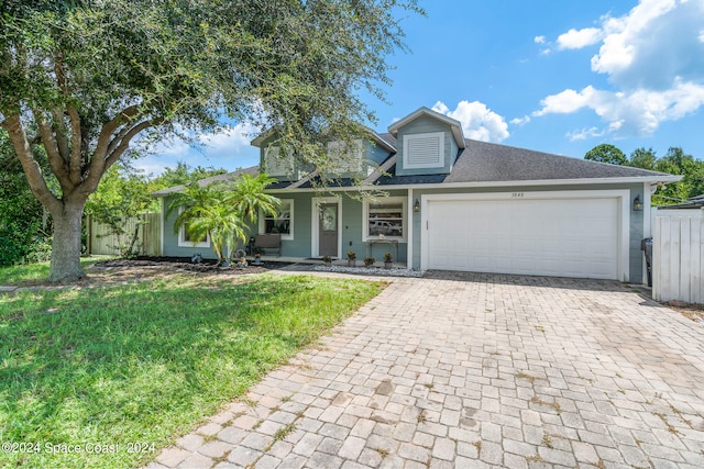 view of front facade featuring a garage and a front lawn