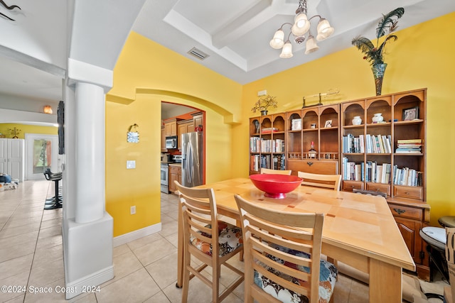 tiled dining room featuring ornate columns, a raised ceiling, and a notable chandelier