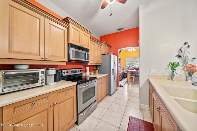 kitchen featuring appliances with stainless steel finishes, ceiling fan, light tile patterned flooring, and sink