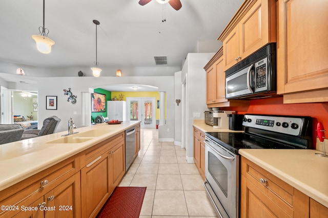 kitchen featuring appliances with stainless steel finishes, sink, pendant lighting, light tile patterned floors, and ceiling fan