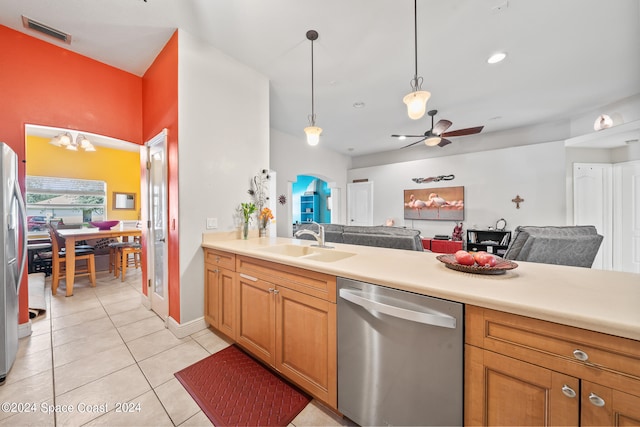 kitchen with stainless steel appliances, sink, ceiling fan, light tile patterned flooring, and hanging light fixtures