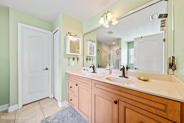 bathroom with tile patterned flooring and vanity