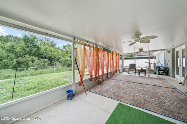 unfurnished sunroom featuring plenty of natural light and ceiling fan