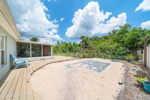 view of pool featuring a sunroom and a wooden deck