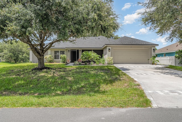 ranch-style house featuring a garage and a front lawn