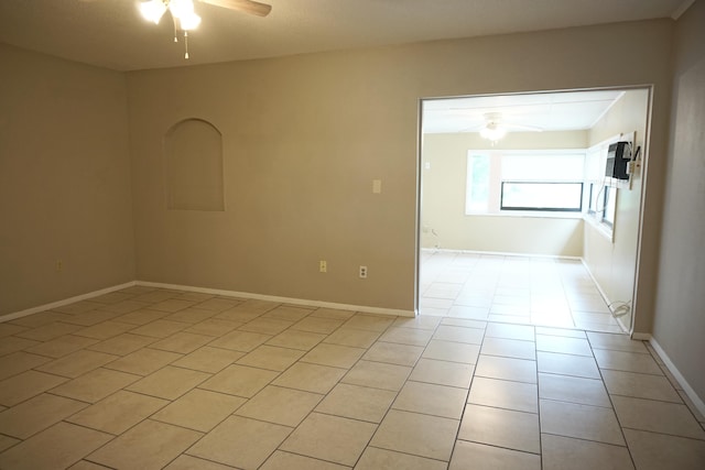 tiled spare room with ceiling fan