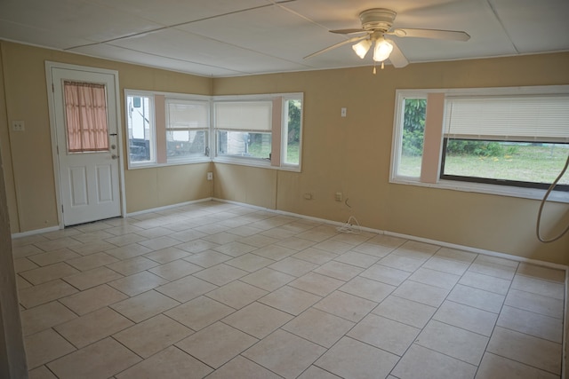 tiled empty room with ceiling fan