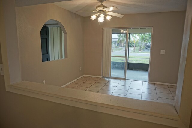 spare room featuring ceiling fan and light tile patterned floors