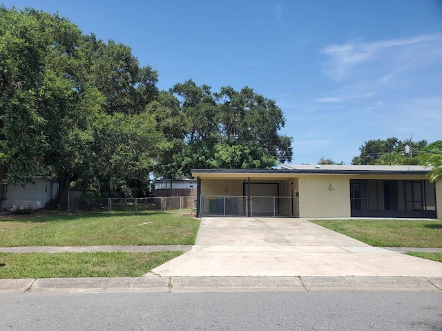 view of front of home with a front lawn and a carport