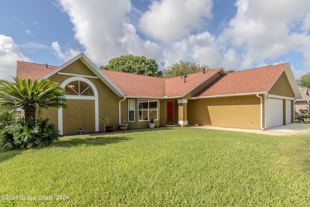 single story home featuring a garage and a front lawn