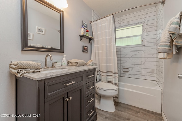 full bathroom featuring vanity, toilet, hardwood / wood-style floors, and shower / bath combo with shower curtain