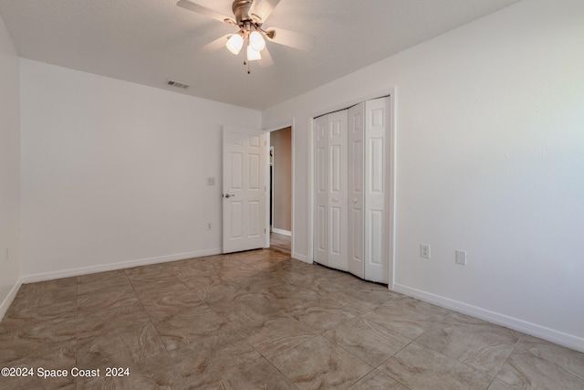 unfurnished bedroom with a closet, ceiling fan, and light tile patterned flooring