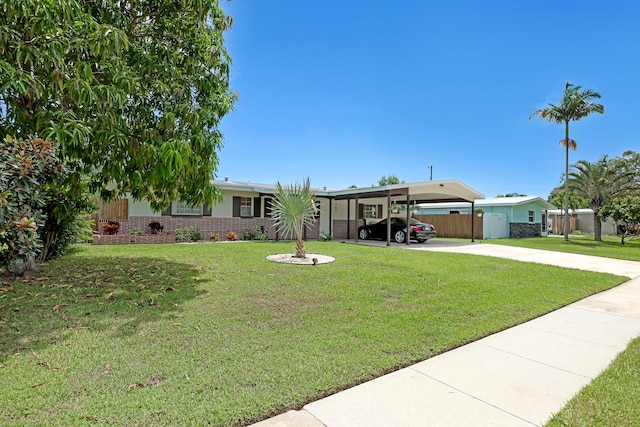 view of front of house with a carport and a front yard