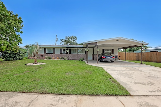 ranch-style home with a carport and a front lawn