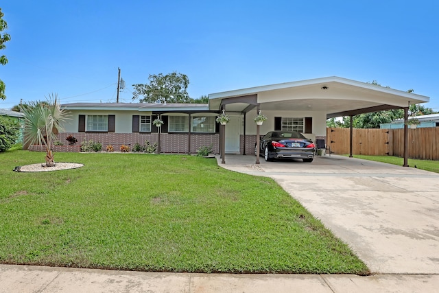 ranch-style house with a carport and a front lawn