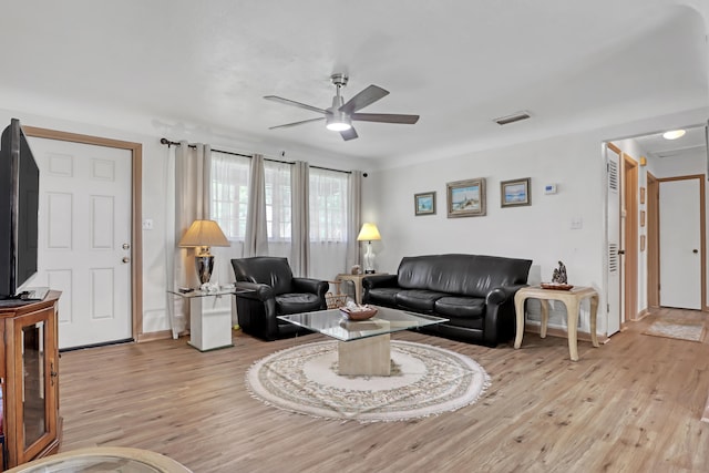 living room with ceiling fan and light hardwood / wood-style flooring