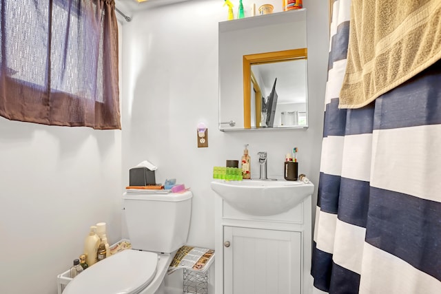 bathroom featuring toilet and vanity