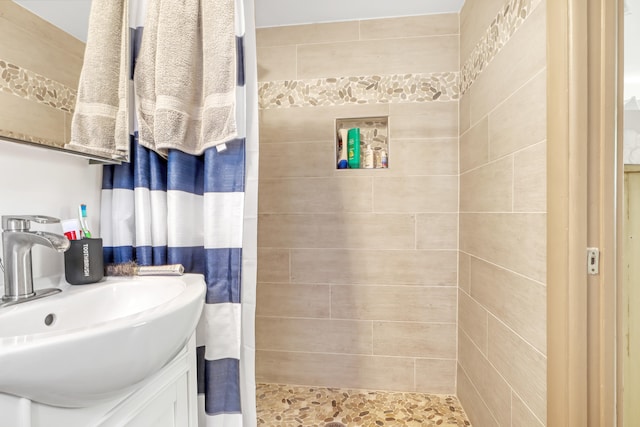 bathroom with curtained shower and vanity