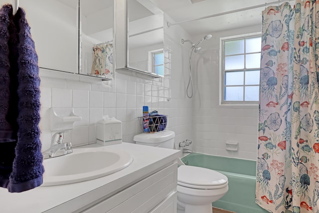 full bathroom with shower / tub combo, tile walls, decorative backsplash, toilet, and vanity