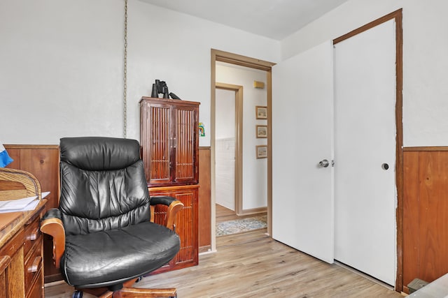 home office with light hardwood / wood-style flooring