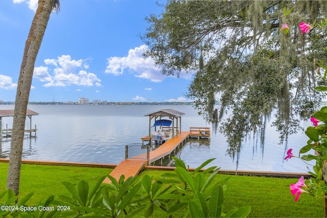 dock area featuring a water view and a lawn