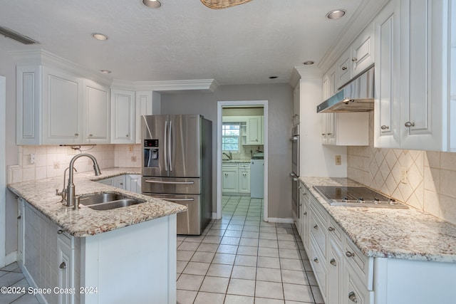 kitchen with sink, white cabinets, light tile patterned flooring, appliances with stainless steel finishes, and light stone counters