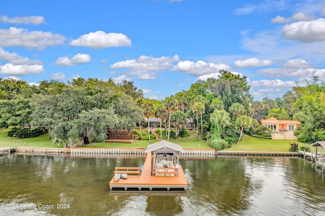 dock area with a water view and a yard