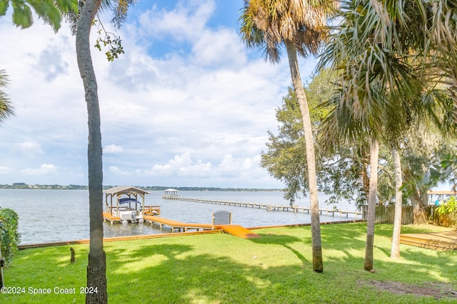 dock area featuring a water view and a yard