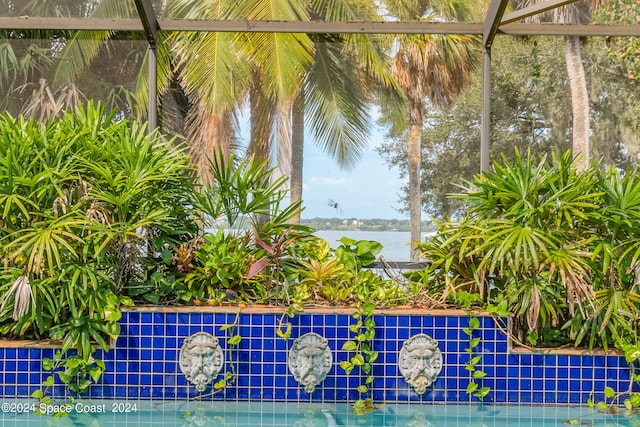 view of pool featuring a water view