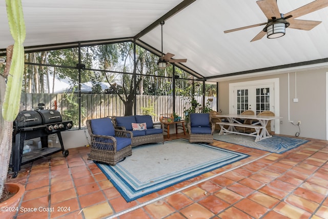 sunroom / solarium with french doors, lofted ceiling with beams, and ceiling fan