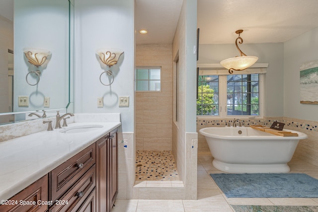 bathroom with vanity, tile walls, tile patterned floors, and separate shower and tub