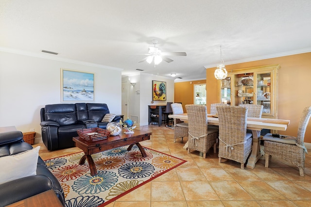 tiled living room featuring ornamental molding and ceiling fan with notable chandelier