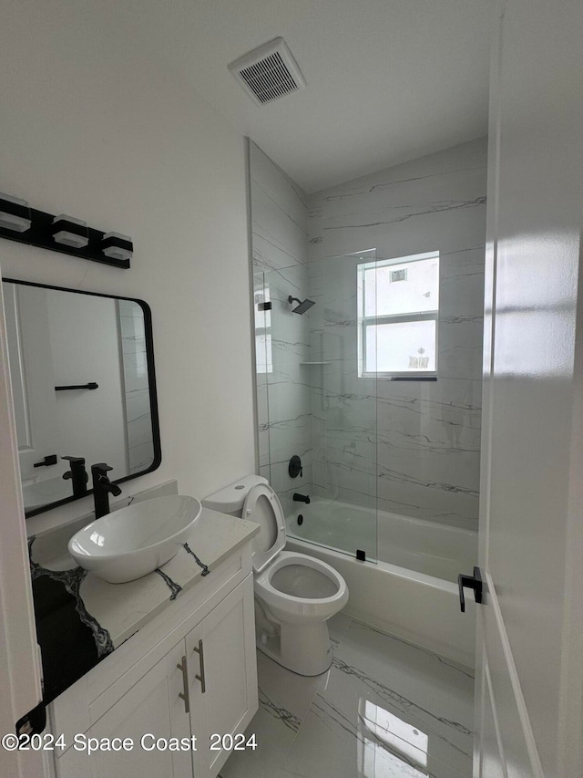 bathroom featuring marble finish floor, bath / shower combo with glass door, visible vents, toilet, and vanity