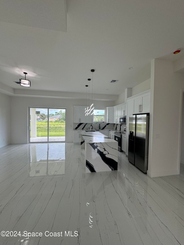 kitchen featuring visible vents, white cabinetry, open floor plan, marble finish floor, and appliances with stainless steel finishes