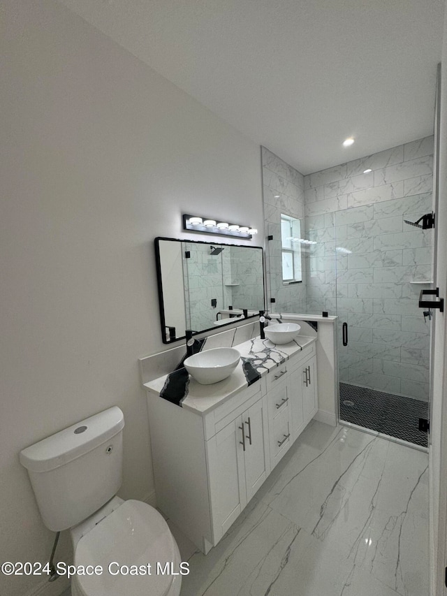 full bath with marble finish floor, a stall shower, a sink, and toilet