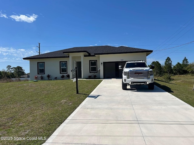 view of front of property featuring a garage, driveway, a front yard, and stucco siding