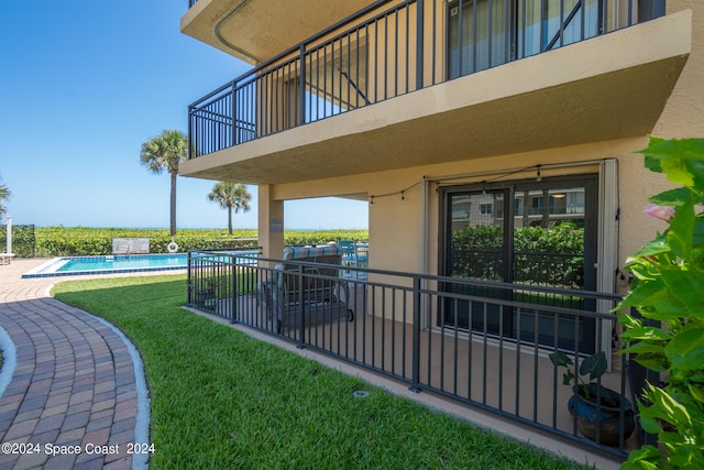 exterior space featuring a balcony and a community pool