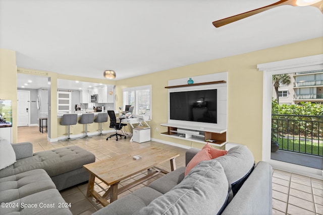 tiled living room with ceiling fan